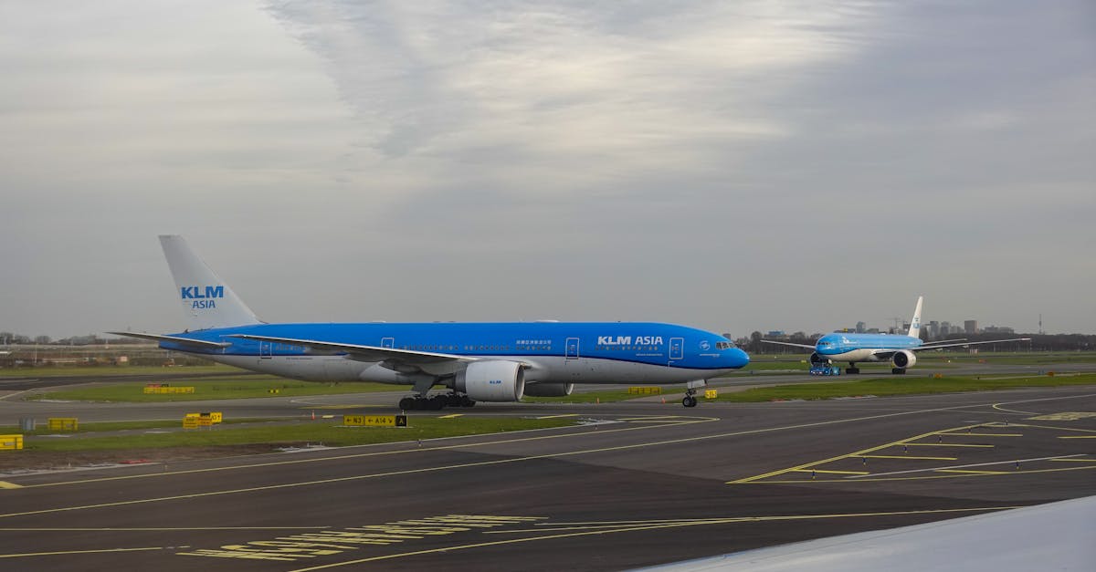 KLM airplanes on the runway at Schiphol Airport, Netherlands, ready for takeoff.